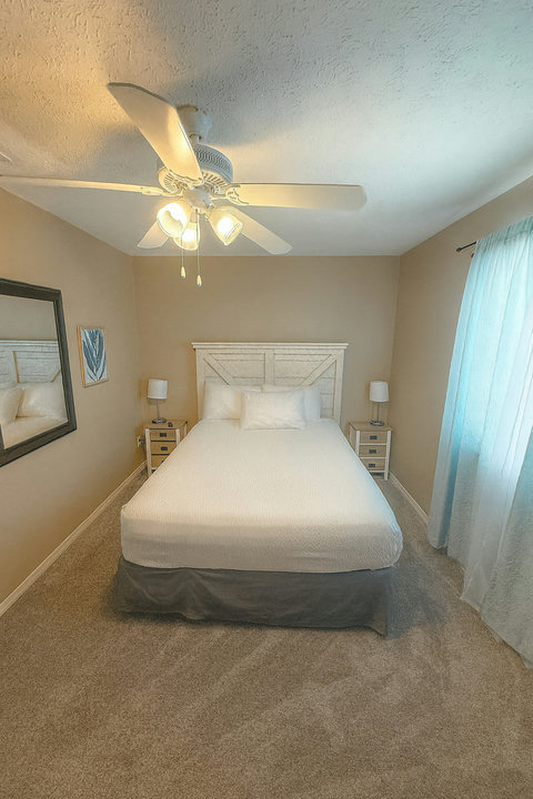 White linens bedroom with barn-door headboard