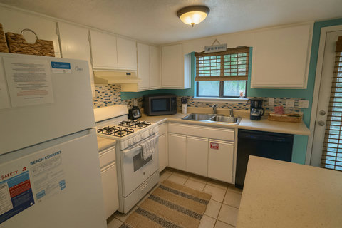 Fully equipped kitchen with fridge, range, and dishwasher