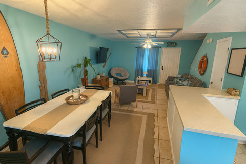 Dining table with rope lantern and vintage surfboard