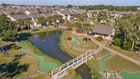 On-site mini golf course with pond and footbridge