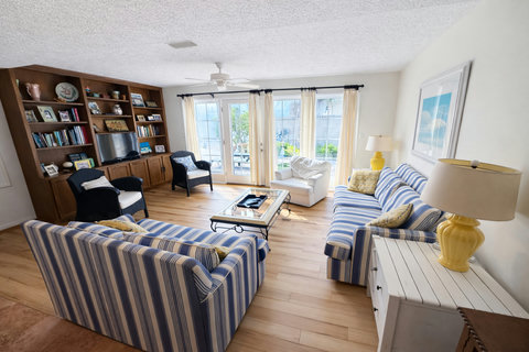 Coastal living room with striped sofas and French doors