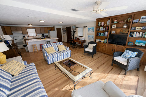 Open living space with built-in TV wall and kitchen