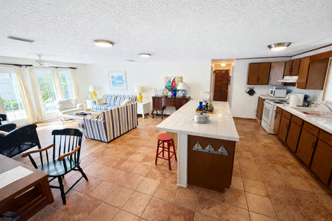 Open kitchen island with sailboat accents and living room