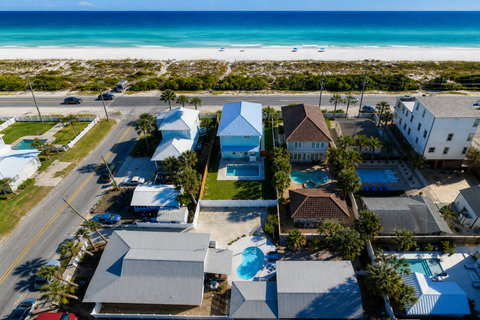 Aerial view: pool home steps from white sand beach