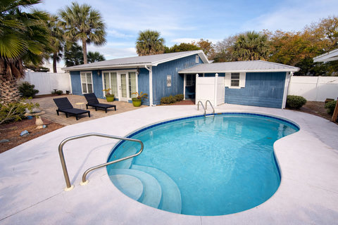 Sparkling backyard pool framed by palm trees