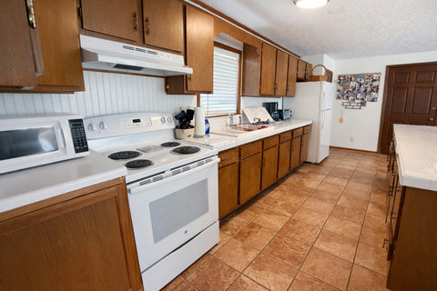 Fully equipped kitchen with wood cabinets and range