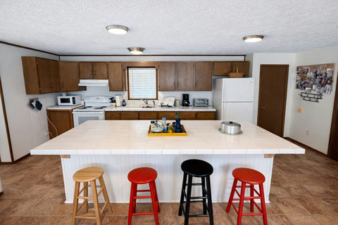 Family kitchen with tiled island and white appliances