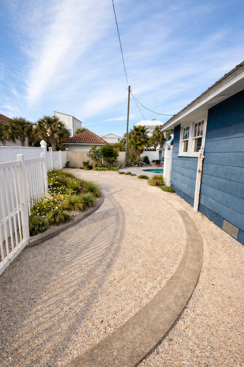 Shell path to the pool through tropical landscaping