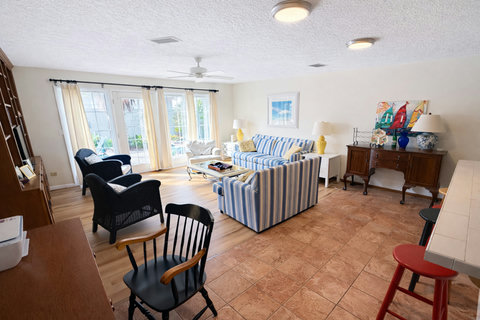 Bright living room opening to sunlit patio doors