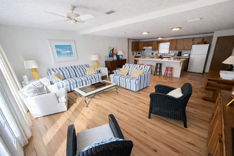 Airy lounge with striped seating and breakfast bar