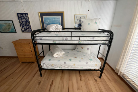Twin bunk beds with seashell linens and cottage walls