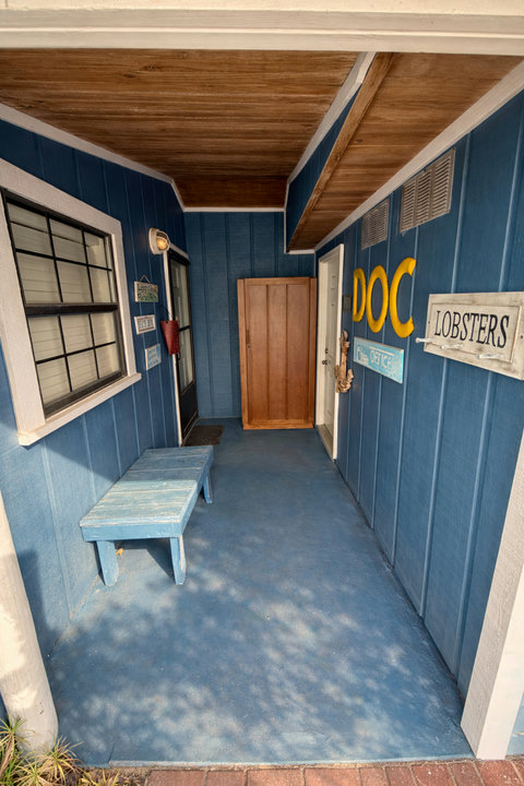 Whimsical nautical entry with coastal blue walls