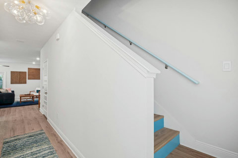 Aqua-riser staircase leading to bright living room