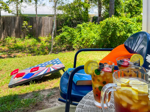 Iced tea and cornhole ready in the fenced yard