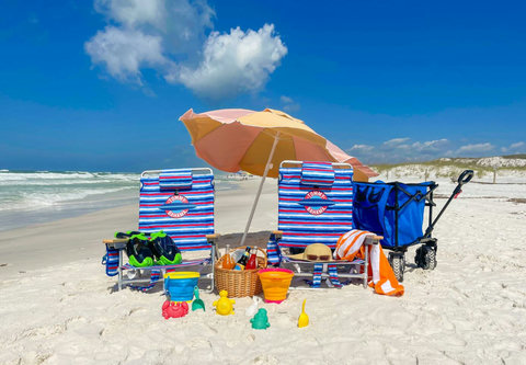Beach chairs, wagon, and toys on white Gulf sand