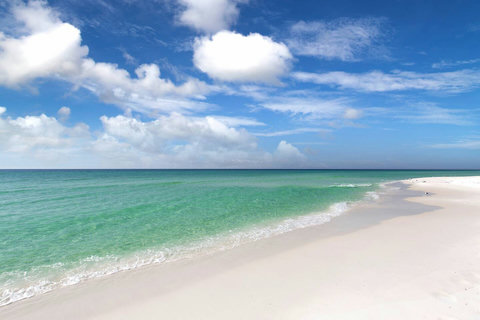 Pristine white sand meeting emerald Gulf water