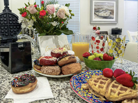 Welcome breakfast of donuts, waffles, and fresh juice