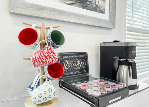 Coffee bar with Keurig, pods, and patterned mugs