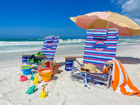 Tommy Bahama chairs and umbrella on turquoise shore