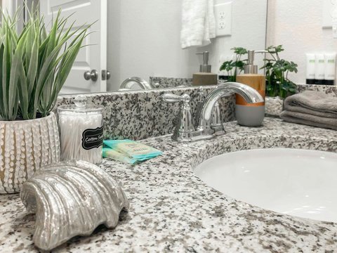 Granite vanity with coastal accents and fresh towels