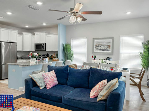 Open living, dining, and kitchen with coastal blues