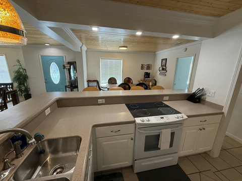 Kitchen sink and range with breakfast bar to dining