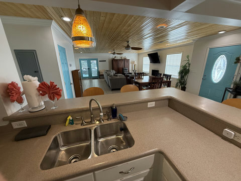 Breakfast bar view into blue-door open living space