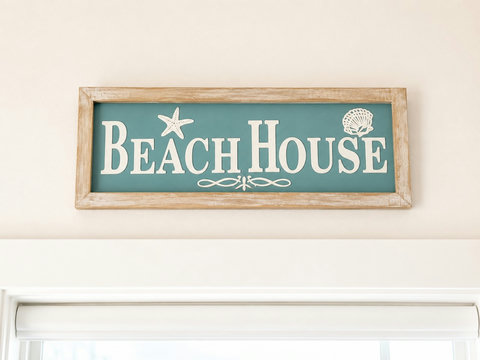 Teal Beach House sign welcoming guests