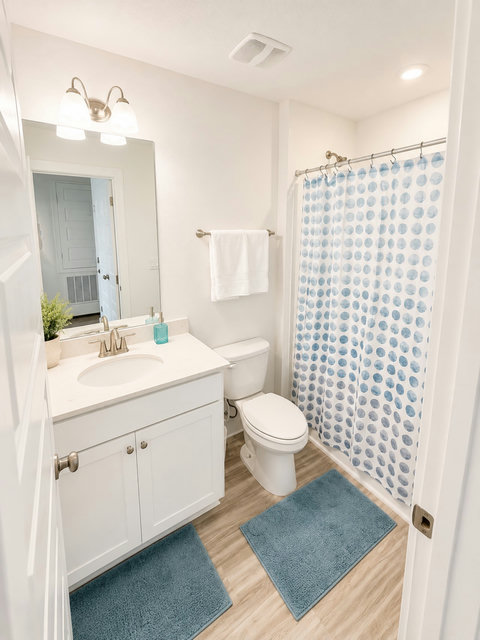 Clean guest bath with blue-dot shower curtain