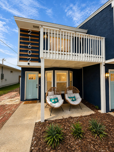 Welcoming front porch with lit egg chairs at dusk