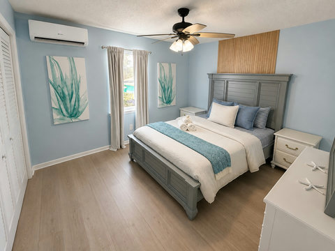 Light blue bedroom with striped pillows and closet