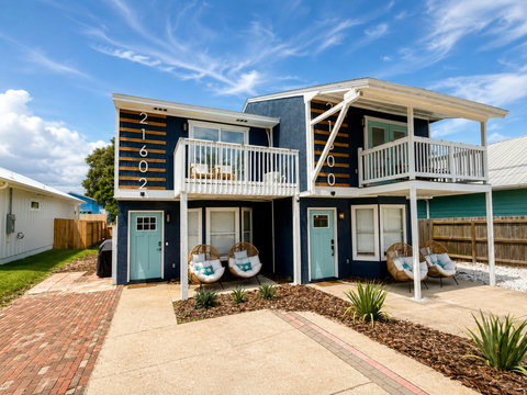 Navy duplex exterior with balconies and egg chairs