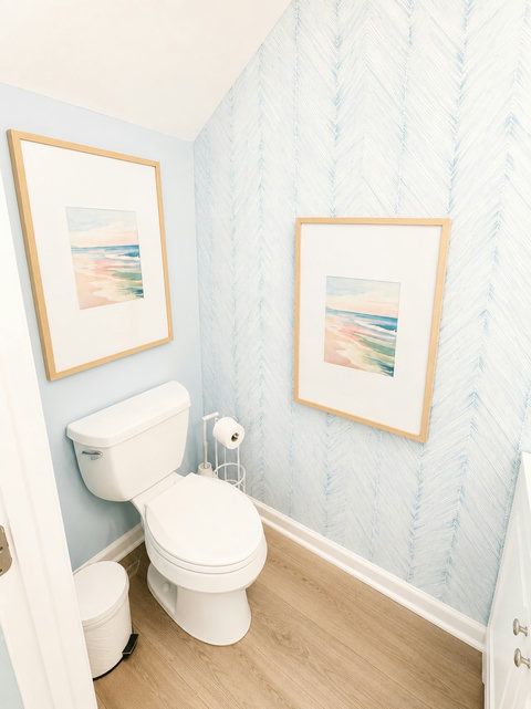 Powder room with soft beach watercolor wall art