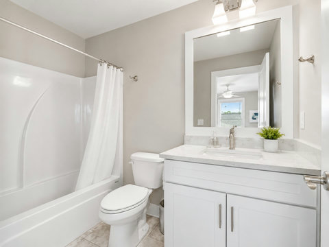 Bathroom – Clean full bath featuring a shower-tub combo, single vanity, and coastal touches.