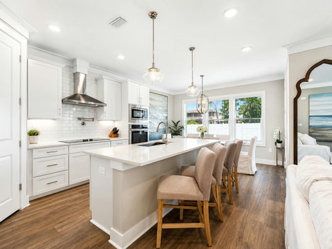 Kitchen – Spacious island with seating for four, gas range, and an open flow into the dining and living areas.