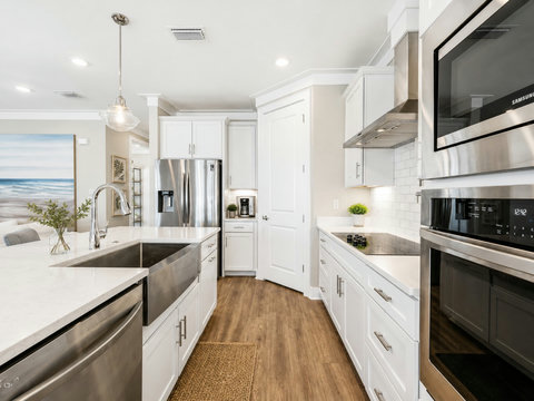 Kitchen – Bright chef's kitchen with a large island, farmhouse sink, quartz counters, and stainless steel appliances.