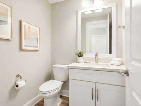 Bathroom – Bright bath with a single vanity, framed coastal art, and a walk-in layout.