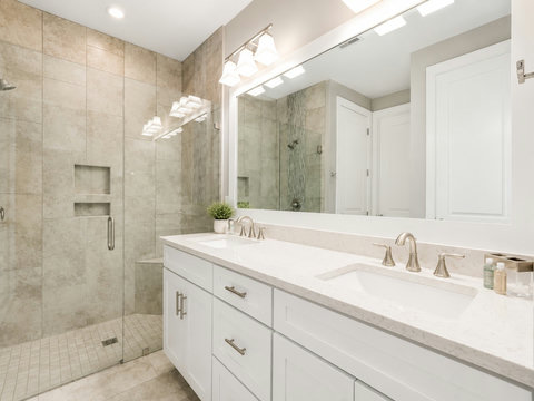 Bathroom – Spa-style bath with a glass walk-in shower, double vanity, and large mirror.