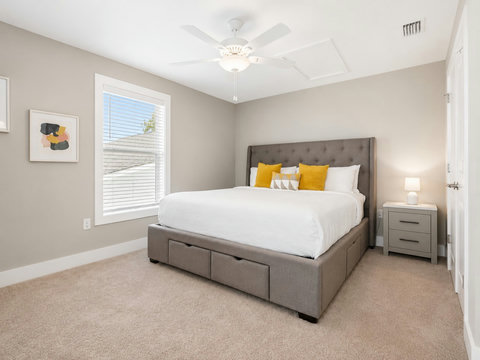 Bedroom – Inviting king bedroom with cheerful yellow accents and a storage platform bed.