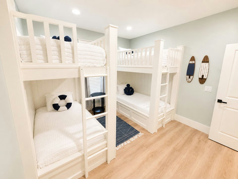 A restful bedroom with a comfy bed, ceiling fan, and plenty of natural light.