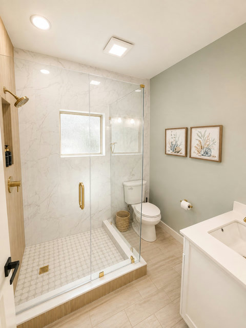 Spa-style bath with a spacious walk-in glass shower and elegant finishes.