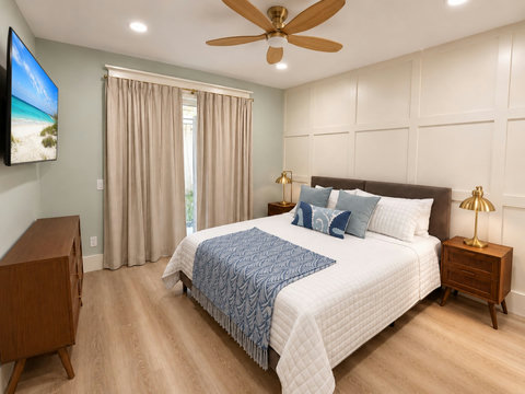 Restful bedroom with a queen bed, soft bedding, and plenty of light.