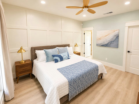 Another inviting bedroom with a cozy queen bed and ceiling fan.