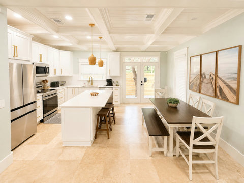 Gather around the farmhouse dining table, open to the chef's kitchen — the perfect spot for family meals.