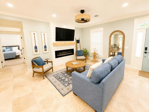 Cozy up by the fireplace in the light-filled living area.