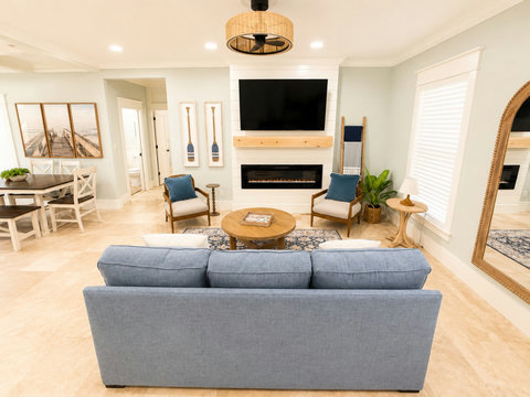 Unwind in the open-concept living room with a plush sofa, cozy fireplace, and smart TV.