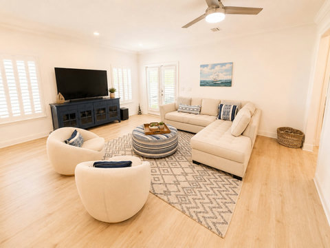 Stretch out in the spacious great room, where a wraparound sectional and warm wood floors make it easy to relax with everyone together.