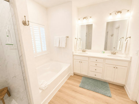 A sleek double-vanity bath with dual sinks, a soaking tub, and marble finishes gives everyone plenty of room to get ready.
