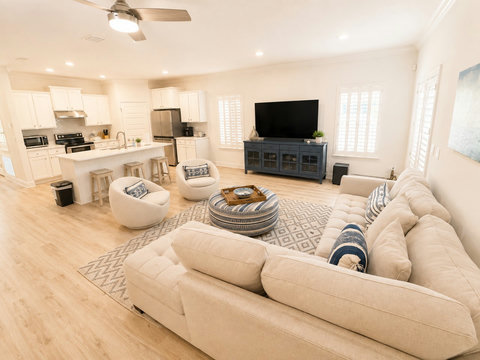 Open-concept living that flows right into the kitchen—gather around the plush sectional and swivel chairs for movie nights and easy conversation.