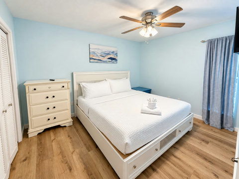 Primary bedroom with dresser and storage